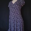 Casual floral dress with a V-neck and short sleeves, featuring pink and purple hues.
