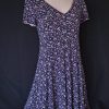 Casual floral dress with a V-neck and short sleeves, featuring pink and purple hues.