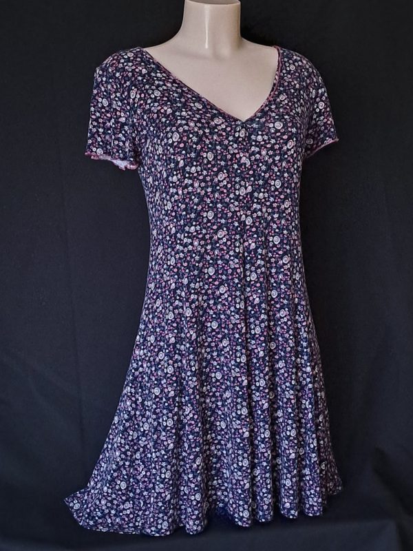 Casual floral dress with a V-neck and short sleeves, featuring pink and purple hues.