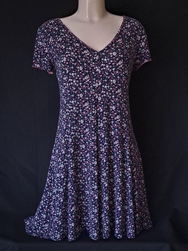 Casual floral dress with a V-neck and short sleeves, featuring pink and purple hues.