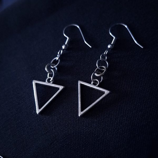 A pair of dangle earrings featuring silver triangle frames and three small round rings connecting them to silver hooks.